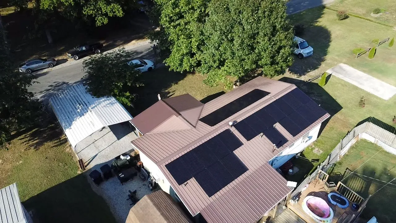 Drone view of a solar panel layout designed across the metal roof of an Illinois home