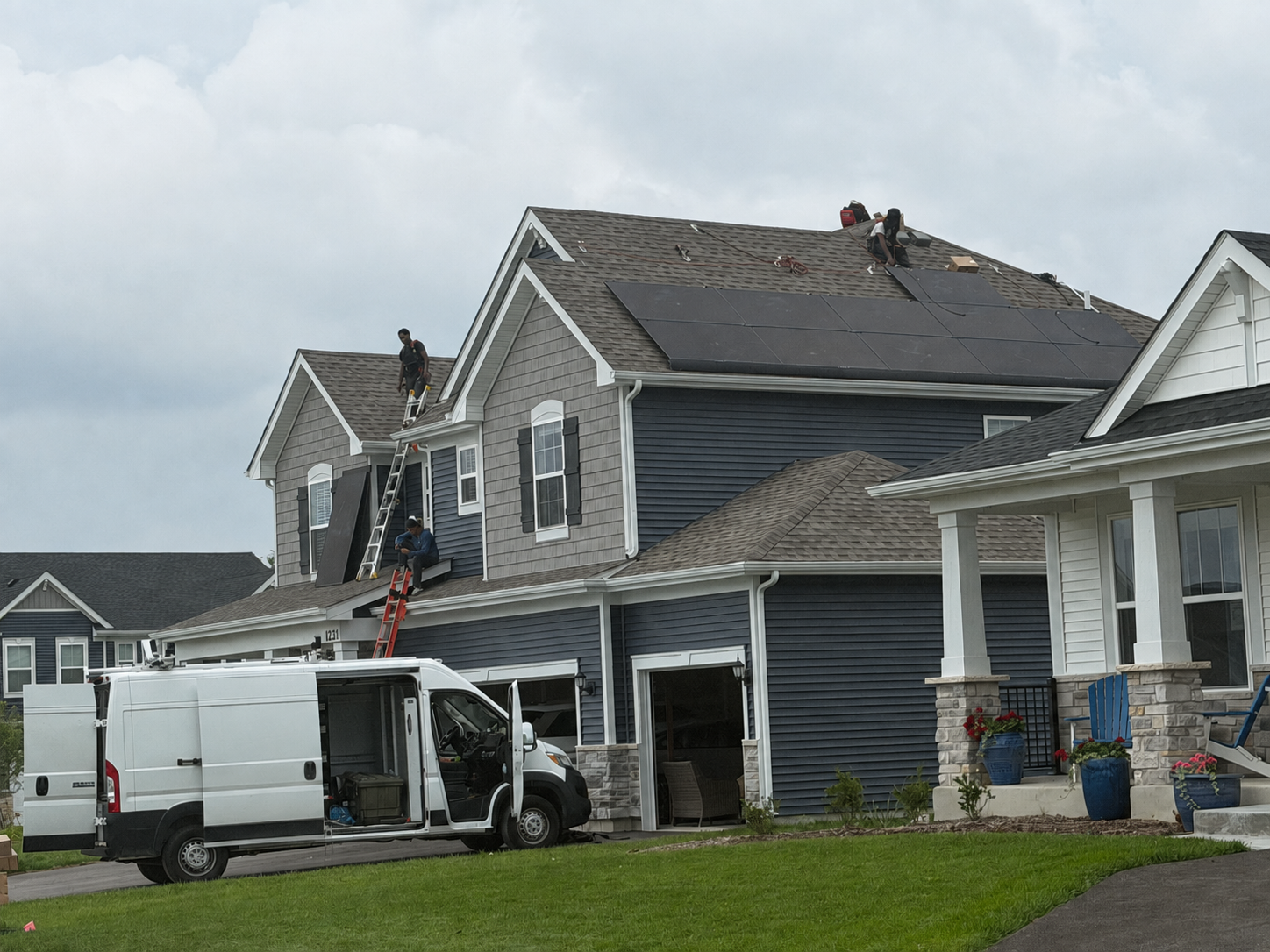 Licensed installation crew setting solar panels on a residential roof