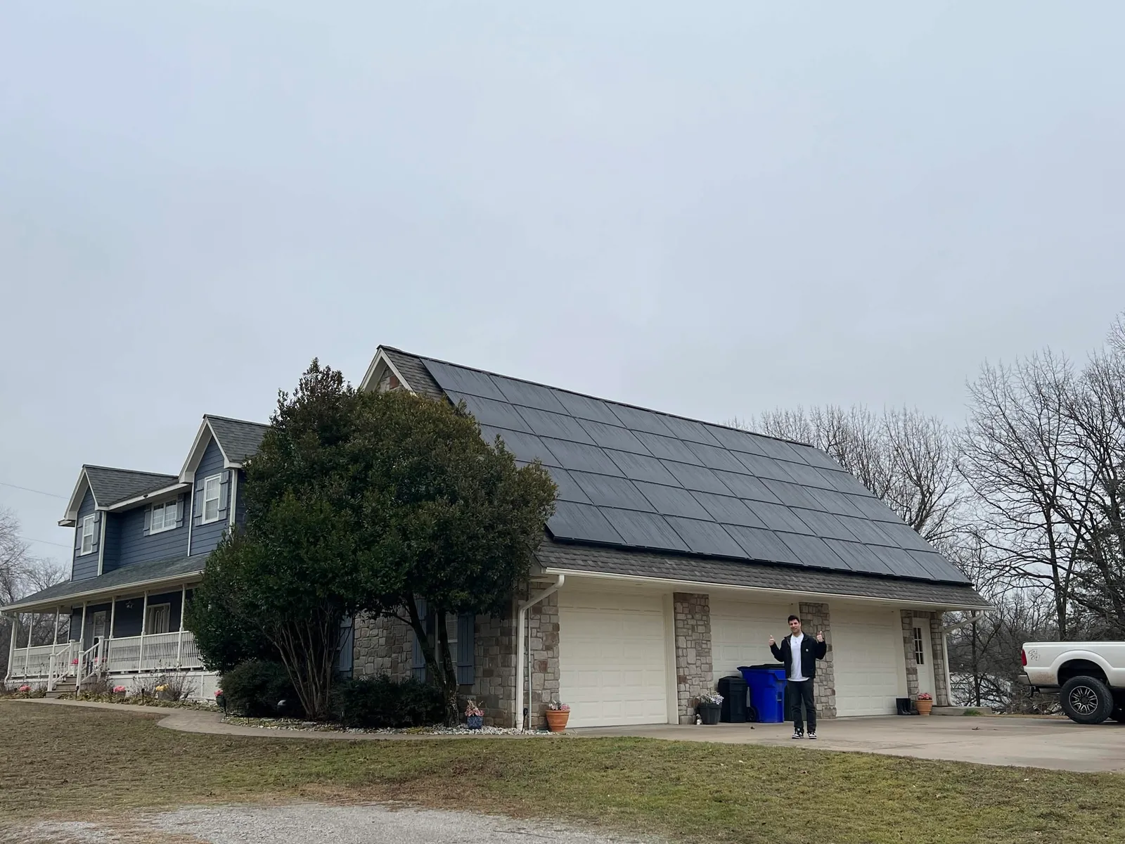 Blue two-story Northern Illinois home with a full solar array on its attached garage roof